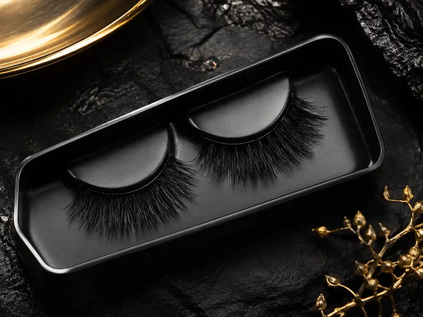 Luxury false eyelashes in a black tray with gold accents